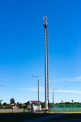 Obraz premium Cellular Base Station or Base Transceiver Station. Telecommunication tower. Wireless Communication Antenna Transmitter. 3G, 4G and 5G Cell Site with blue and cloudy sky.