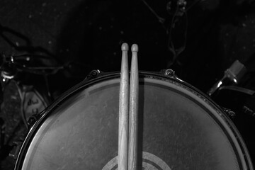 Photo of drumsticks on a drum kit. Music background