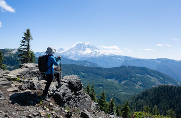 Woman enjoying the view of Mt Rainier on the Summit Lake trail. Mt Rainier National Park. Washington State.