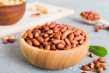 Fresh healthy peanuts in bowl on colored table background. Top view Healthy eating bertholletia concept. Super foods