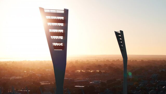 AERIAL Sun Shinning Through Sporting Stadium Light Towers, CLOSE UP