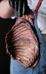 butcher showcasing smoked rib rack