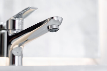 Water Tap. Water flow from chromed steel faucet