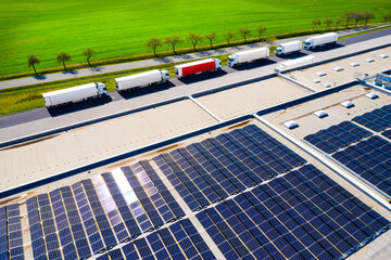 Electric cars charging from a solar power plant on the roof of a warehouse. Sustainable technologies reduce emissions in transport.