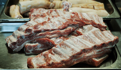  raw ribs prepared for smoking in professional kitchen