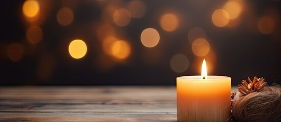 An amber candle, made of wax, sits on a wooden table emitting a warm orange flame. The heat from the fire tints the room in shades of orange as you sip your drink