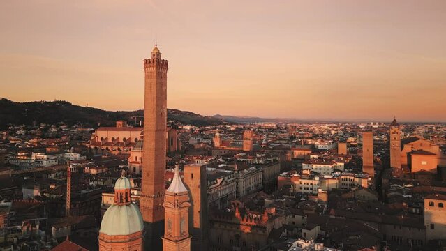 bologna city centre aerial view drone at sunrise flying to asinelli tower landmark with san petronio basilica in the background