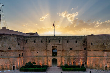 Photograph taken at the Aragonese Castle of the city of Taranto in Puglia, during a wonderful sunset. Taken outdoors in February 2024. - obrazy, fototapety, plakaty