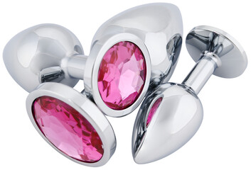 Set stainless steel anal butt plugs with a pink crystal different sizes isolated on a transparent background.. Completely in focus.