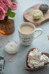 A portion of meringue in a small wooden plate in the shape of a heart