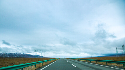 Hainan Mongolian and Tibetan Autonomous Prefecture, Qinghai Province-Grasslands and roads under the snow-capped mountains