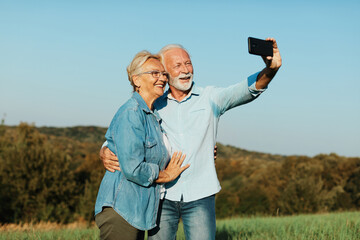 woman man outdoor senior couple happy lifestyle retirement together smiling love selfie camera mature - 763073716