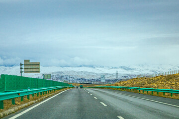 Hainan Mongolian and Tibetan Autonomous Prefecture, Qinghai Province-Train under the snowy mountains