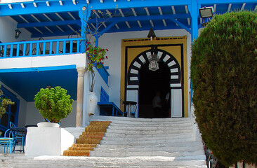 typical Moorish cafe in the old city Sidi Bou Said (Tunisia, North Africa); two locals inside; a...