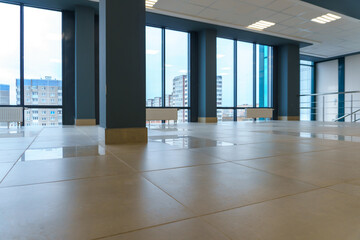 Panoramic windows in an empty spacious room. Installation of fiberglass windows in the business center.