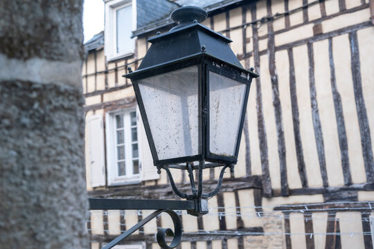 Street lantern with a timbered house in back - Vannes France 