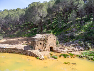 Aerial drone view of old watermill in the shore of Odiel river in the hiking route of the water mills along the Odiel river from Sotiel Coronada, in Huelva province, Andalusia, Spain