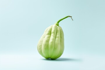 A single chayote squash isolated on a teal background, with space for text.