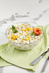 Fresh crab salad with corn, egg, and cucumber in a clear bowl, perfect for a light and healthy meal