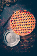 Kersenvlaai. Dutch cherry pie. Cherry pie with dough lattice from Limburg, Netherlands. Handbaked open cherry pie, delicious sweet dessert served on a wooden table.