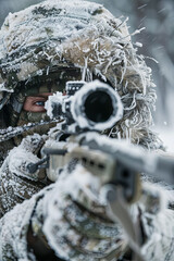 Sniper in a winter camouflage shoots from a rifle - obrazy, fototapety, plakaty