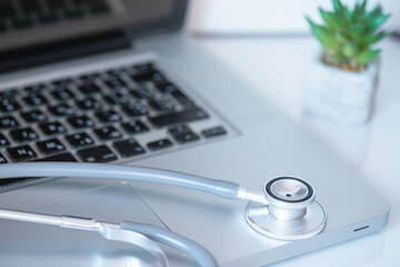 Integration of technology and healthcare: stethoscope resting on a laptop keyboard. - Powered by Adobe