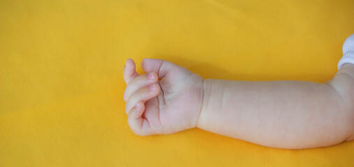 baby sleeps on a yellow background. child