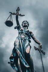 Majestic Statue of Lady Justice Under a Cloudy Sky, Symbolizing Fairness and Law