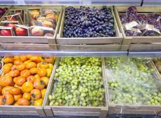 Man buying fruits (grape) at the market