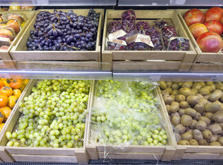 Man buying fruits (grape) at the market