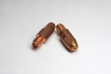 MIG welding contact tips pair. Threaded tail, tapered, shaped