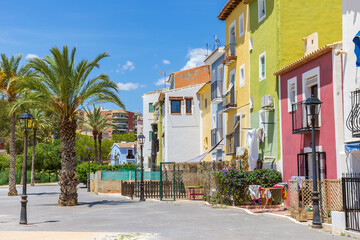 Palm trees and colorful houses on the boulevard of Villajoyosa, Spain