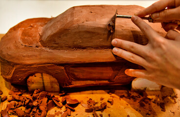 Designers work on the car's sculpture using carving tools. Adjust the surface of the model. in the automotive industry