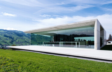 Fototapeta na wymiar Beautiful modern house with glass walls overlooking the mountains of Switzerland