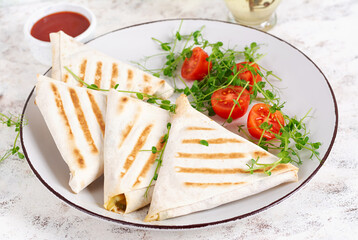 Fototapeta na wymiar Tasty breakfast with lavash. Mexican cuisine. Trending food with pita bread, cheese, tomatoes and spinach