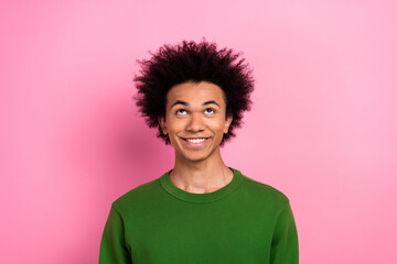 Photo of happy positive guy look up empty space isolated over pastel color background