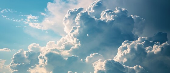 Voluminous white cumulus clouds building up in a clear blue sky, suggesting an imminent change in weather