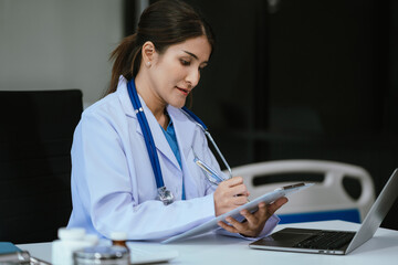 Medical Technology Concepts The doctor is working on a tablet and audio player and a digital tablet computer in a modern office in the morning at the desk..