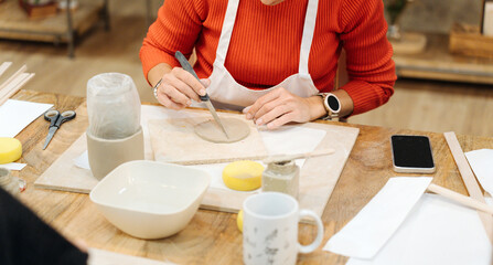 Fototapeta na wymiar Clay Artistry: Female Friends Crafting Vases