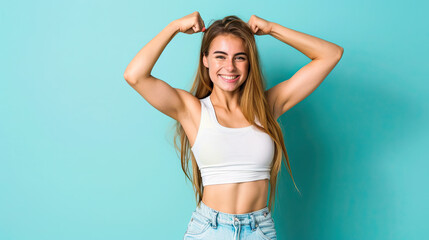 Obraz premium Young caucasian fitness woman doing sport isolated showing strength gesture with arms on pastel blue background