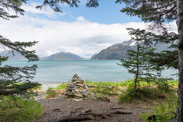 Stone cairn at the entrance to the beach overlooking  Chilkat Inlet from the Battery Point Trail in the Chilkat State Park, Alaska, USA