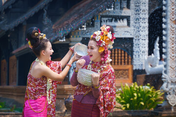 Songkran festival . Pretty Asian women playing with water-splashing Songkran. Beautiful Thai...