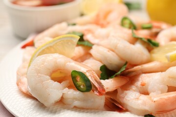 Tasty boiled shrimps with chili and parsley on table, closeup