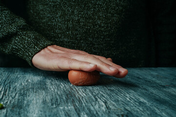 man rolling a hard-boiled egg - 763156725