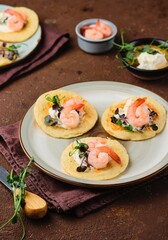 Pancakes with cream cheese, microseneous and shrimp on a ceramic plate on a brown concrete background. Pancakes recipes, snacks. International Pancake Day.