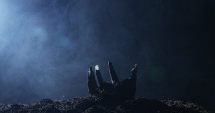 Zombie hand rising out from the ground
