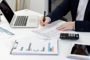 Professional analyzing financial reports at office desk