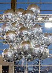 Cluster of Helium Filled Foil Silver Balloons in Hall