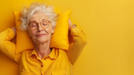 Elderly woman sleeping on pillow isolated on pastel yellow colored background Sleep deeply peacefully rest. Top above high angle view photo portrait of satisfied .senior wear yellow shirt - Powered by Adobe