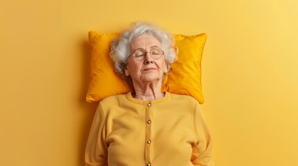 Elderly woman sleeping on pillow isolated on pastel yellow colored background Sleep deeply...